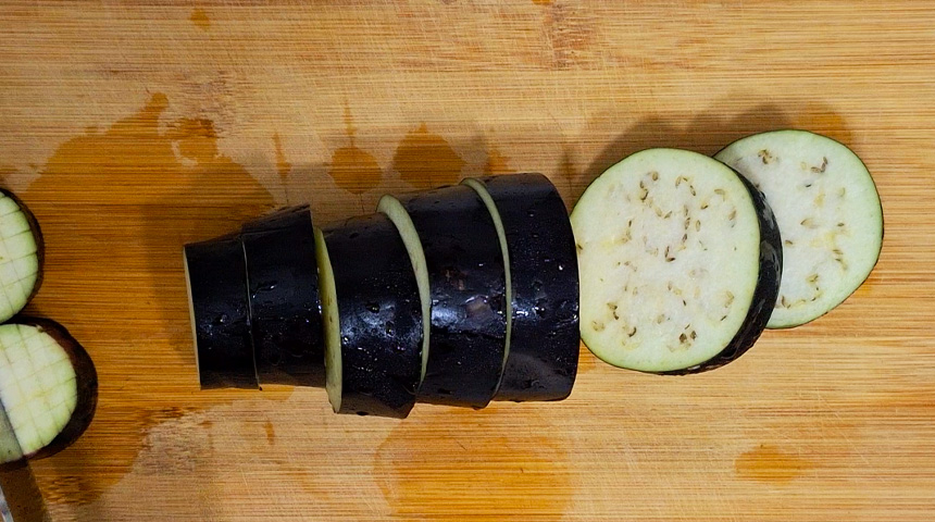 Grilled eggplant starts with slicing the eggplant into thick, hearty pieces